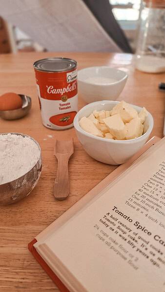 Products placed on the table before preparing the cake: tomato soup can, butter, flour, sugar